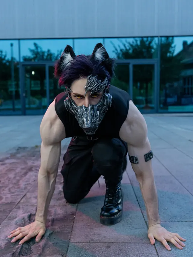 Cinematic cosplay portrait in a dark creature-inspired look with handcrafted face armor.
