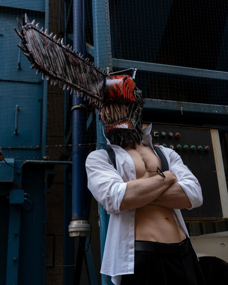 Cosplay portrait with a handcrafted chainsaw helmet and industrial styling.