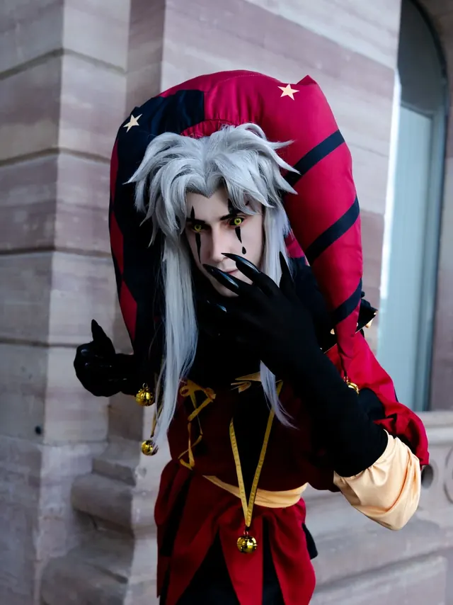 Jester-inspired cosplay portrait with white hair, dramatic makeup and red-black costume.