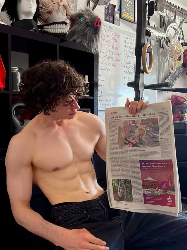 Ihor Kostash holding the printed HNA feature in his workshop.