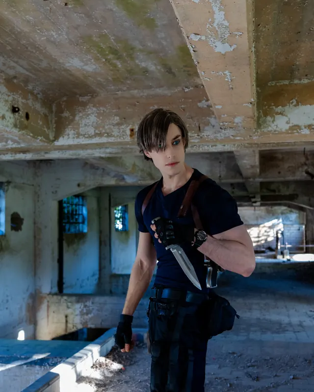 Leon S. Kennedy cosplay portrait in an abandoned building holding a combat knife, wearing a dark tactical outfit with shoulder holster.
