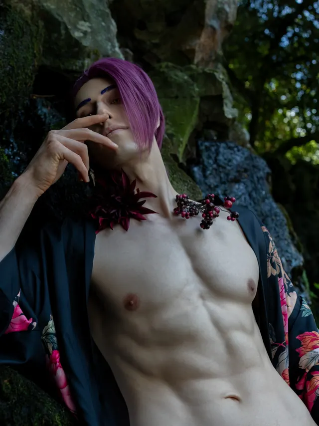 Close Rien cosplay portrait with purple hair and a dark floral robe against mossy stone.