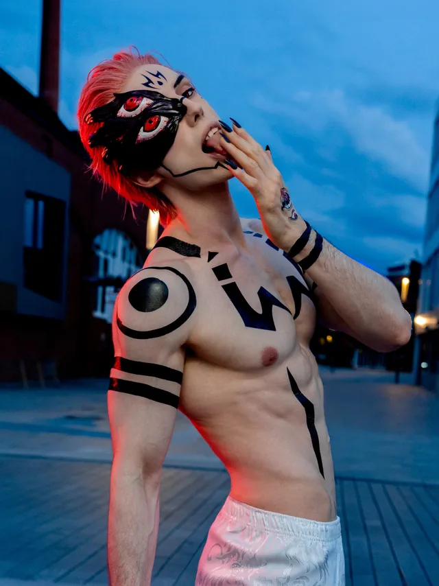 Sukuna cosplay in an evening portrait with the handcrafted eye mask and character styling.