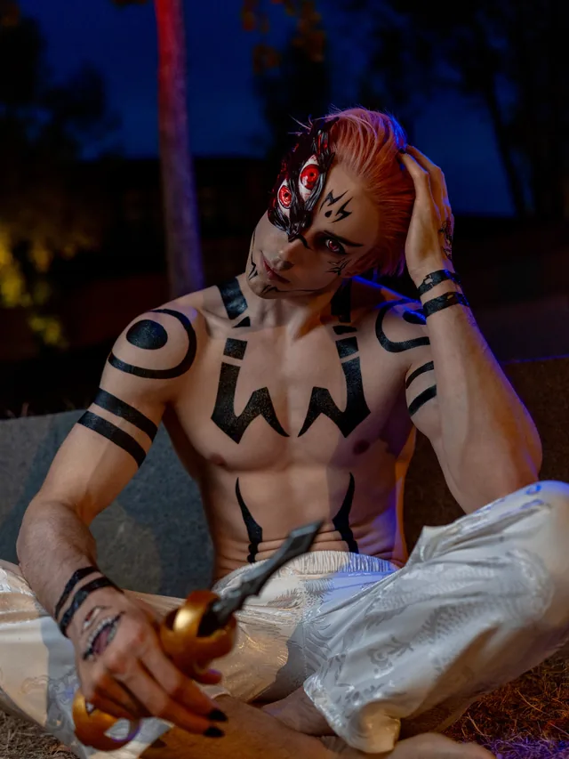Sukuna cosplay with a handcrafted 3D-printed eye mask and prop weapon.
